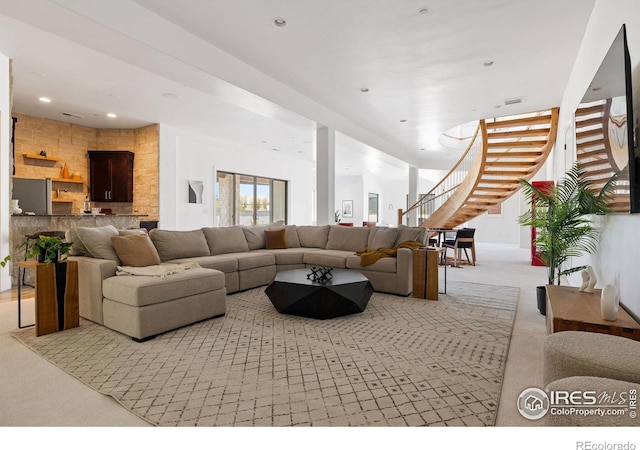 living area featuring visible vents, recessed lighting, carpet, and stairs