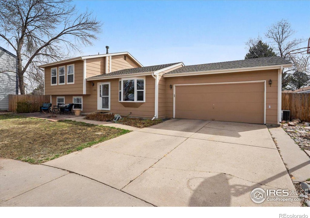 2030 Lexington Ct, Fort Collins, CO 80526 - split level home with an attached garage, fence, and driveway