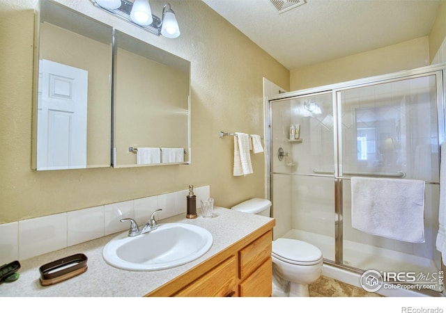 835 Kane Dr Unit 25, Longmont, CO 80501 - bathroom featuring vanity, visible vents, a stall shower, and toilet
