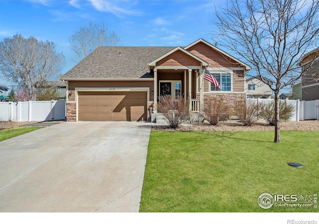 2118 74th Avenue Ct, Greeley, CO 80634 - craftsman-style home with a front yard, fence, stone siding, an attached garage, and concrete driveway