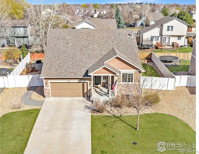 2118 74th Avenue Ct, Greeley, CO 80634 - view of front of property with a fenced backyard, stone siding, a residential view, and concrete driveway