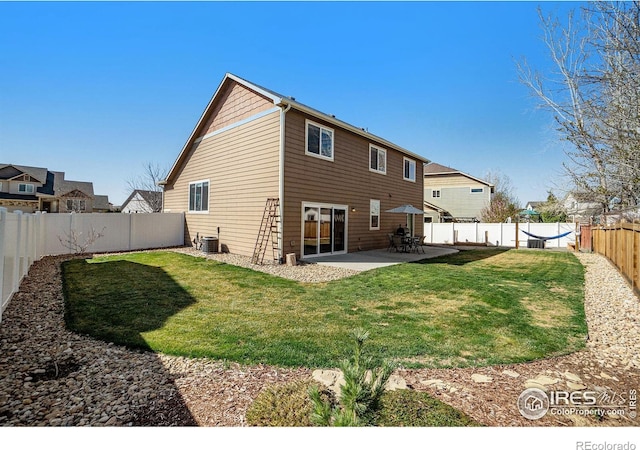 2118 74th Avenue Ct, Greeley, CO 80634 - rear view of house featuring central AC, a fenced backyard, a yard, and a patio area