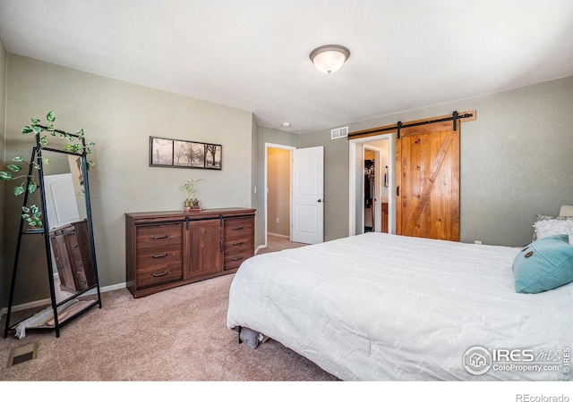 2118 74th Avenue Ct, Greeley, CO 80634 - bedroom featuring light carpet, a barn door, visible vents, and baseboards