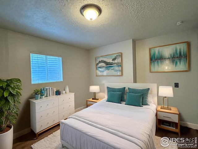 1616 Longbow Ct, Lafayette, CO 80026 - bedroom featuring a textured ceiling and wood finished floors