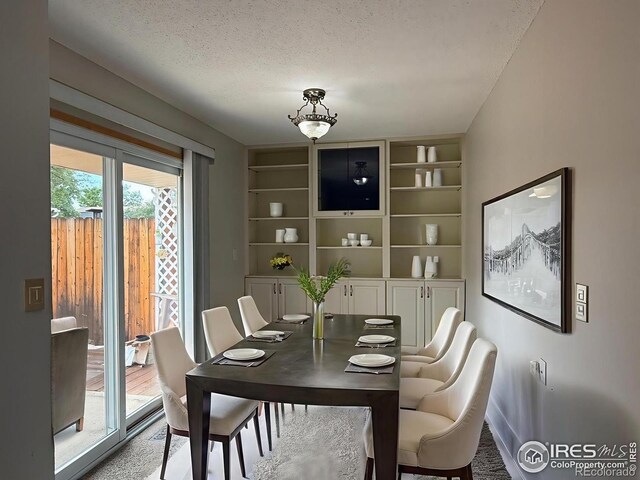 1616 Longbow Ct, Lafayette, CO 80026 - dining space with built in shelves and a textured ceiling