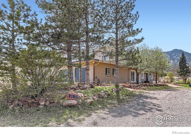3786 Eldorado Springs Dr, Boulder, CO 80303 - view of front of property with stucco siding and a mountain view