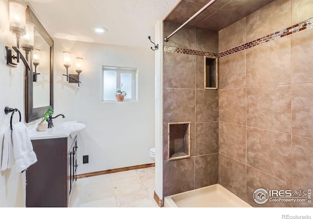 3786 Eldorado Springs Dr, Boulder, CO 80303 - bathroom featuring vanity, baseboards, toilet, and tiled shower