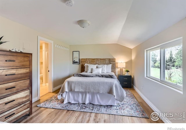 3786 Eldorado Springs Dr, Boulder, CO 80303 - bedroom featuring baseboards, ensuite bathroom, wood finished floors, and lofted ceiling