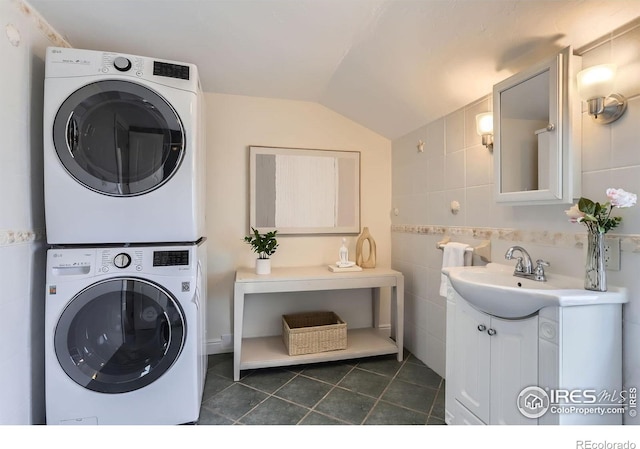 3786 Eldorado Springs Dr, Boulder, CO 80303 - washroom featuring laundry area, a sink, tile walls, dark tile patterned floors, and stacked washer and clothes dryer