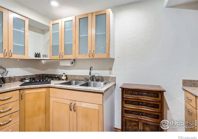 3786 Eldorado Springs Dr, Boulder, CO 80303 - kitchen with light brown cabinetry, a sink, light countertops, glass insert cabinets, and a textured wall