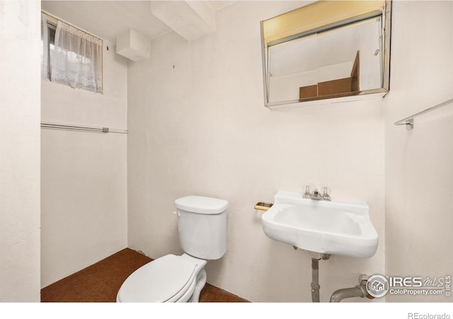 bathroom featuring toilet and a sink