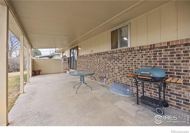 view of patio featuring fence and area for grilling