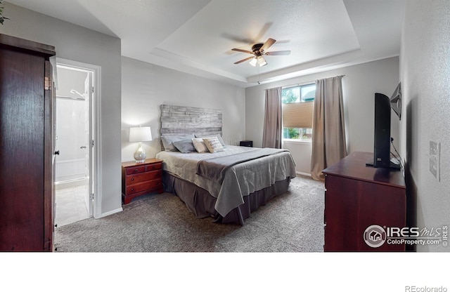 5543 Calgary St, Timnath, CO 80547 - bedroom with a tray ceiling, carpet flooring, baseboards, ceiling fan, and ensuite bathroom
