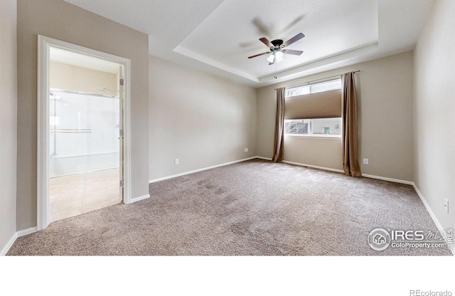 5543 Calgary St, Timnath, CO 80547 - carpeted empty room featuring a ceiling fan, a tray ceiling, and baseboards