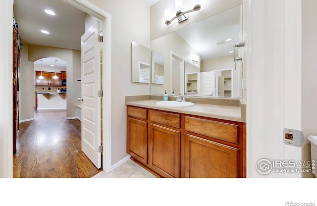 5543 Calgary St, Timnath, CO 80547 - bathroom with vanity, wood finished floors, baseboards, and recessed lighting