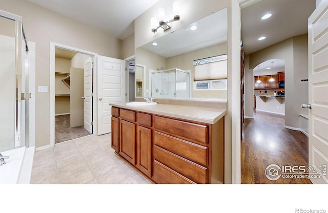 5543 Calgary St, Timnath, CO 80547 - full bath featuring a stall shower, vanity, a spacious closet, recessed lighting, and baseboards
