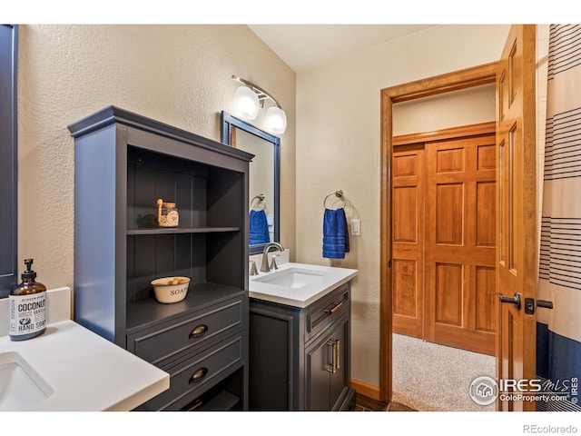 bathroom featuring vanity, a textured wall, and a heating unit