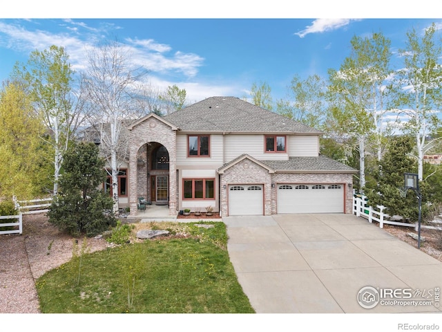 view of front of property with fence, concrete driveway, brick siding, and a garage