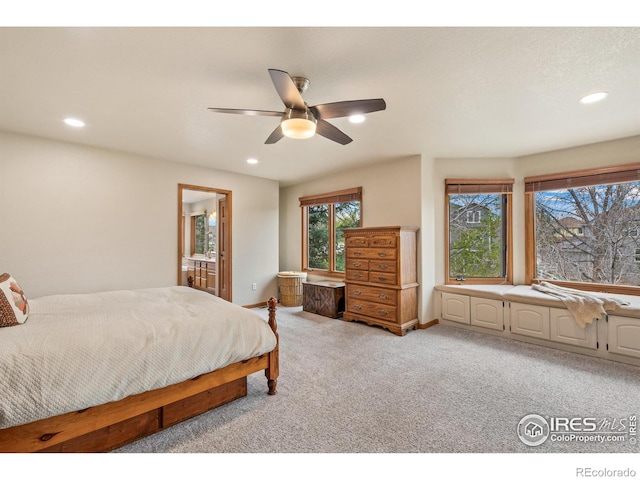 bedroom featuring light colored carpet, recessed lighting, baseboards, and ensuite bathroom