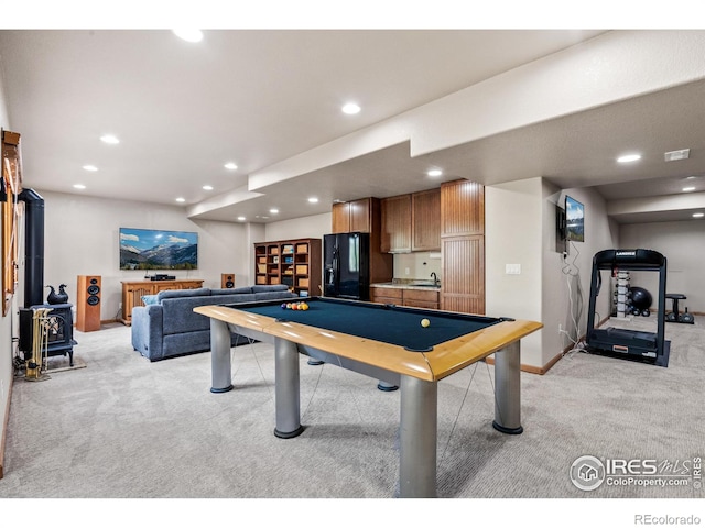 game room with recessed lighting, a wood stove, pool table, and light carpet