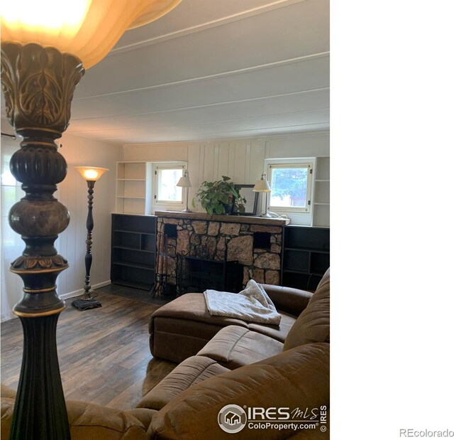 198 Poudre River Rd, Bellvue, CO 80512 - living room with baseboards, a stone fireplace, and wood finished floors