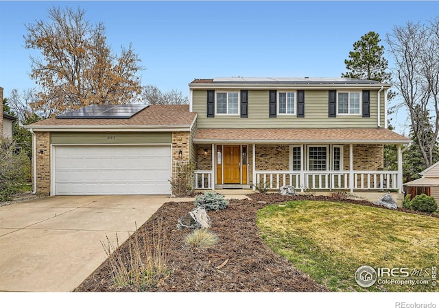 357 W Harper St, Louisville, CO 80027 - traditional home featuring a porch, a front yard, brick siding, an attached garage, and concrete driveway