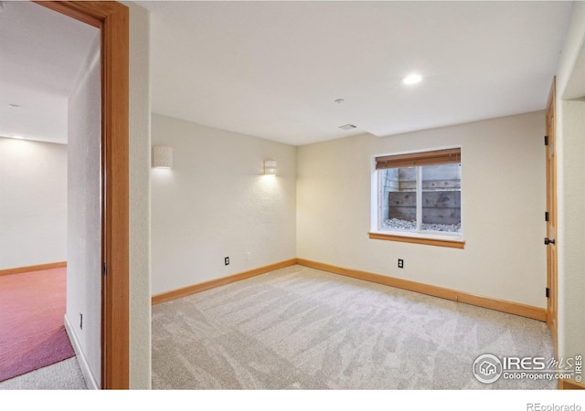 unfurnished room featuring recessed lighting, baseboards, and carpet