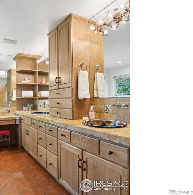 full bathroom with decorative backsplash, tile patterned flooring, a sink, and double vanity