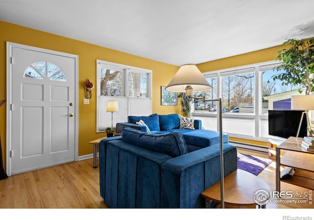 2276 Goss Cir, Boulder, CO 80302 - living room featuring light wood-style flooring, a baseboard radiator, a wealth of natural light, and baseboards