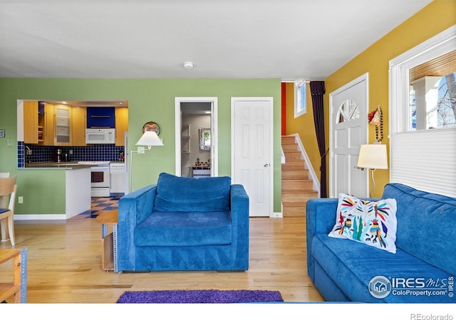 2276 Goss Cir, Boulder, CO 80302 - living area with stairway, light wood-style flooring, and baseboards