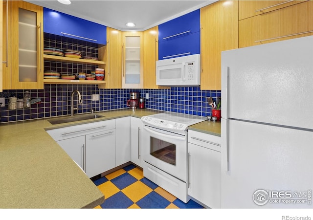 2276 Goss Cir, Boulder, CO 80302 - kitchen with white appliances, backsplash, light countertops, recessed lighting, and glass insert cabinets