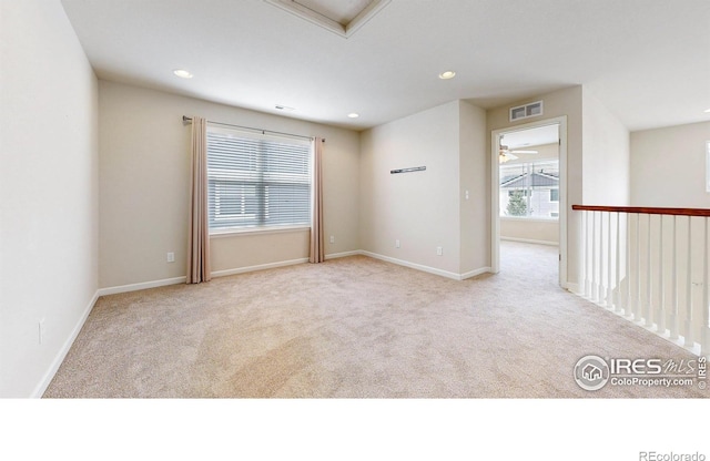 carpeted spare room featuring recessed lighting, visible vents, baseboards, and a ceiling fan