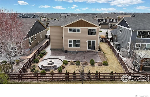 6748 Rainier Rd, Timnath, CO 80547 - view of front of house with a patio, a fire pit, a residential view, entry steps, and a fenced backyard