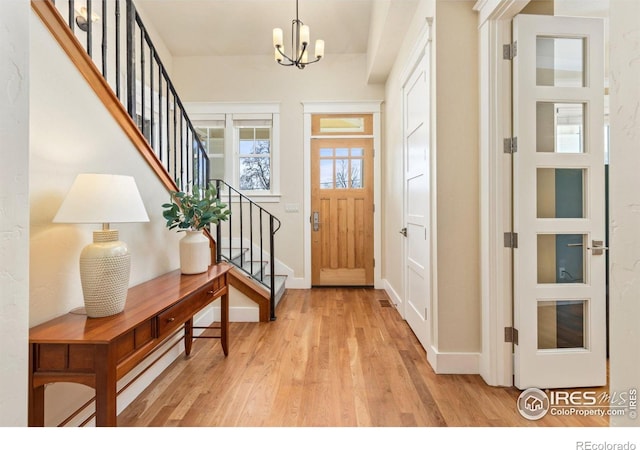 245 Spruce St, Louisville, CO 80027 - entrance foyer featuring a chandelier, wood finished floors, baseboards, and stairway