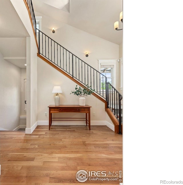 245 Spruce St, Louisville, CO 80027 - staircase featuring baseboards and wood finished floors