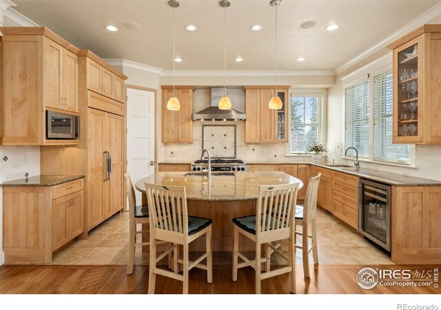 245 Spruce St, Louisville, CO 80027 - kitchen with wall chimney exhaust hood, a sink, light brown cabinetry, wine cooler, and light stone countertops