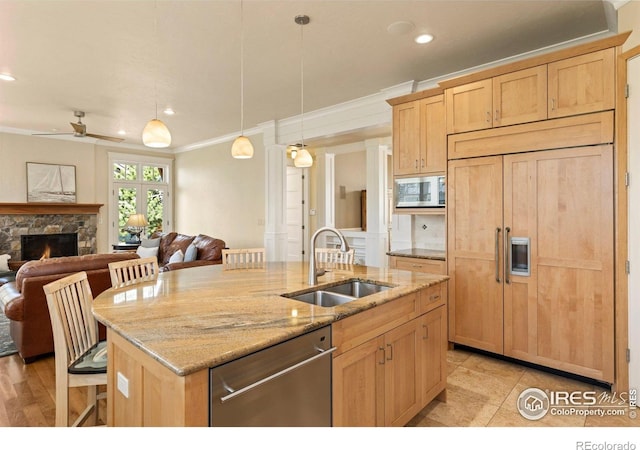 245 Spruce St, Louisville, CO 80027 - kitchen featuring ornamental molding, a sink, open floor plan, built in appliances, and light brown cabinets