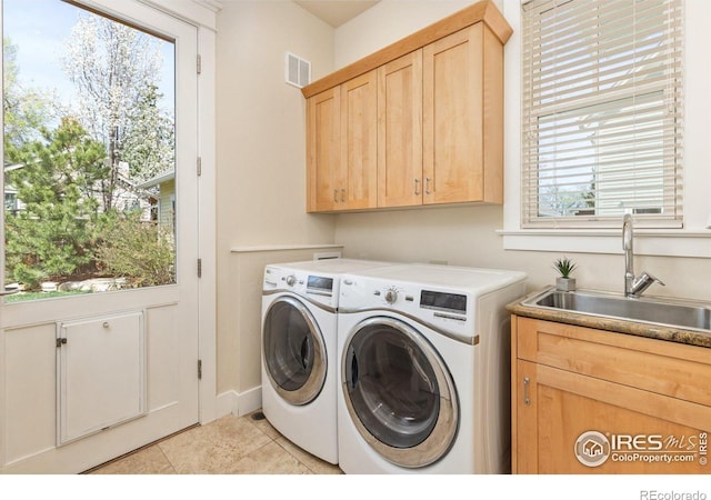 245 Spruce St, Louisville, CO 80027 - laundry area with plenty of natural light, washing machine and dryer, visible vents, cabinet space, and a sink