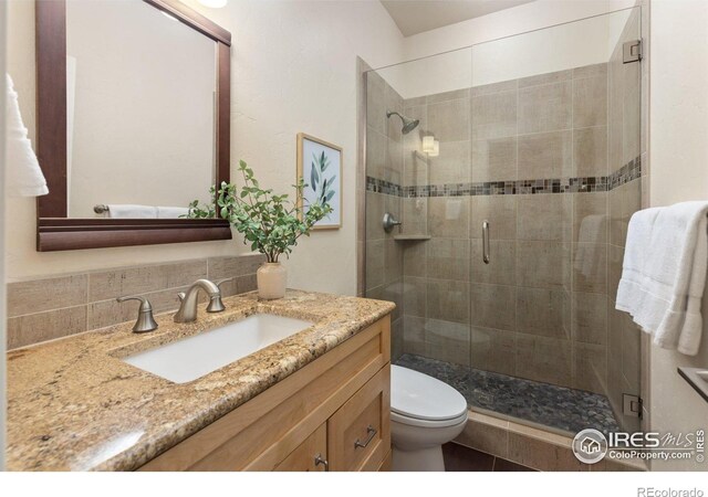 245 Spruce St, Louisville, CO 80027 - full bath with a shower stall, vanity, and toilet