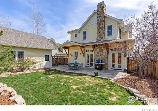 245 Spruce St, Louisville, CO 80027 - back of property with fence, a patio area, french doors, and a chimney