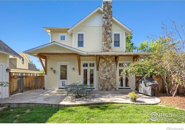 245 Spruce St, Louisville, CO 80027 - rear view of property featuring french doors, a chimney, and a patio