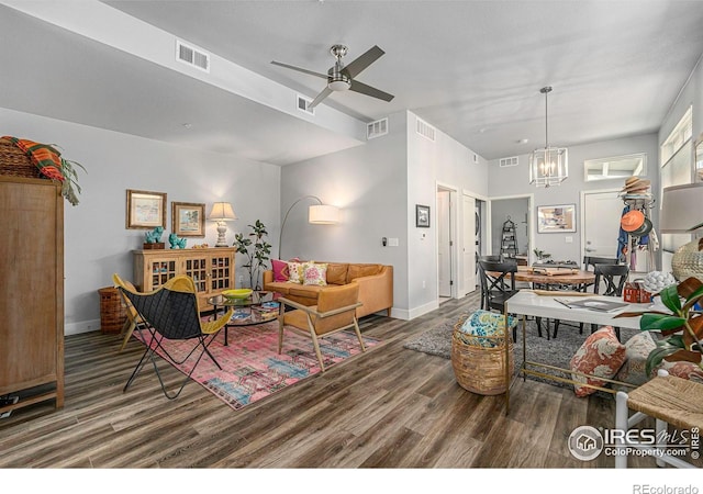 living area with wood finished floors, ceiling fan with notable chandelier, and visible vents