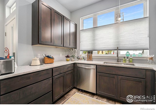 kitchen featuring a sink, light wood-type flooring, dark brown cabinetry, and dishwasher