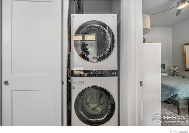 clothes washing area featuring stacked washing maching and dryer and laundry area