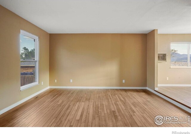 1458 Friendship Ln W, Colorado Springs, CO 80904 - spare room featuring visible vents, light wood-type flooring, and baseboards