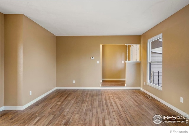 1458 Friendship Ln W, Colorado Springs, CO 80904 - unfurnished room featuring visible vents, wood-type flooring, and baseboards