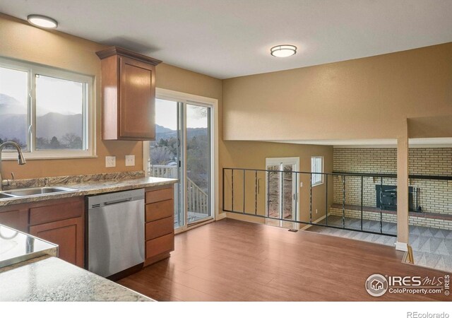 1458 Friendship Ln W, Colorado Springs, CO 80904 - kitchen with a sink, stainless steel dishwasher, brown cabinets, and dark wood-style floors