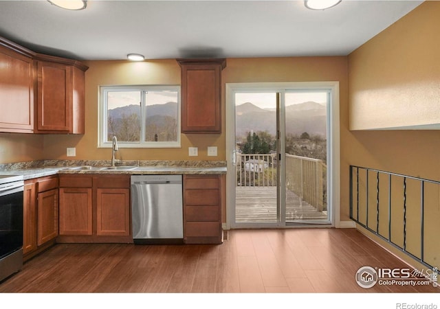 1458 Friendship Ln W, Colorado Springs, CO 80904 - kitchen featuring a sink, brown cabinetry, appliances with stainless steel finishes, and wood finished floors