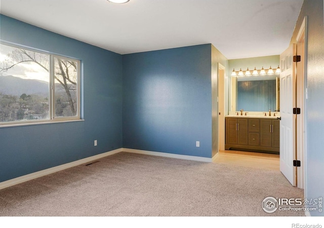 1458 Friendship Ln W, Colorado Springs, CO 80904 - unfurnished bedroom with a sink, baseboards, and carpet floors
