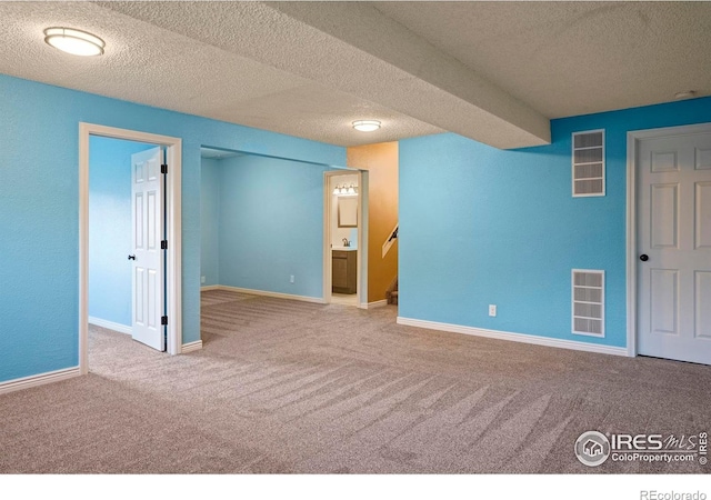 1458 Friendship Ln W, Colorado Springs, CO 80904 - interior space with a textured ceiling, visible vents, carpet floors, a walk in closet, and baseboards